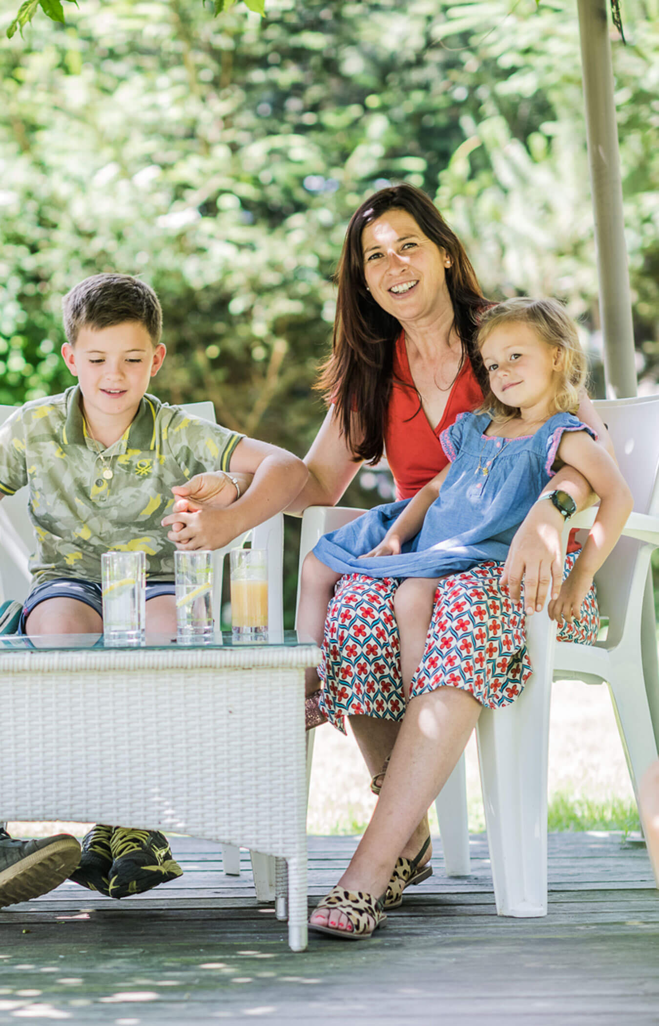 Host Astrid sits on the terrace with her two children - Wirtshaushotel Alpenrose