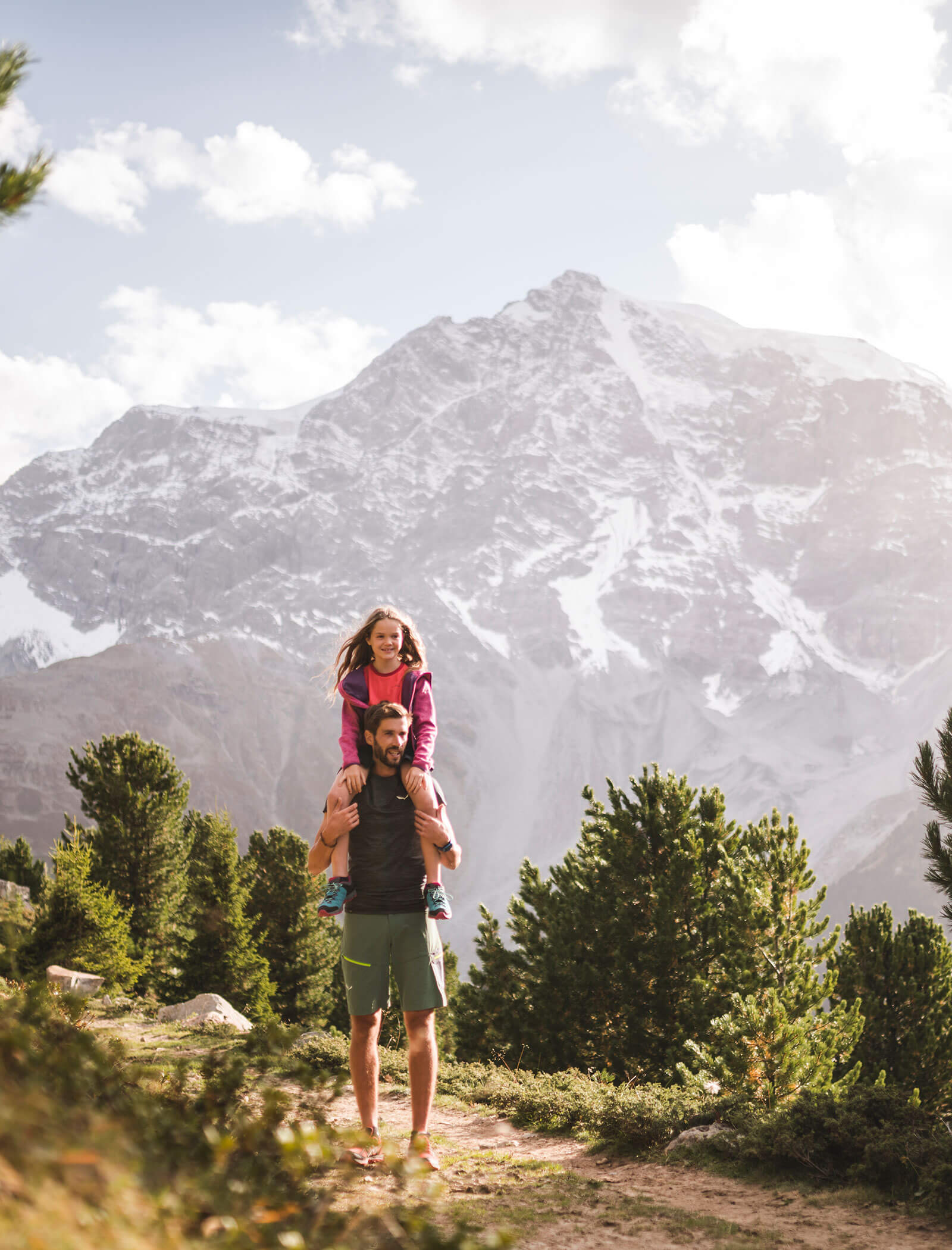 Man with child hiking in the mountains - Wirtshaushotel Alpenrose
